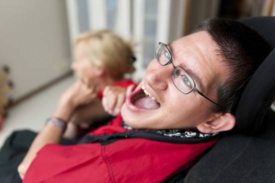 A young man sharing a laugh with his Support Worker, with the ma